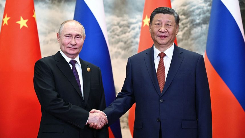 Russia's President Vladimir Putin and Chinese leader Xi Jinping shake hands prior to their talks in Beijing on May 16, 2024.