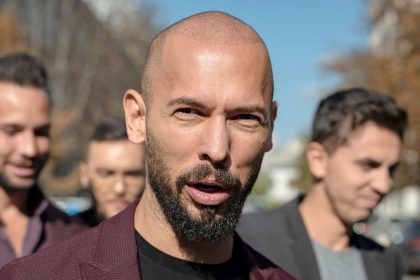 Andrew Tate talks to reporters outside the Court of Appeal on October 15, 2024 in Bucharest, Romania.