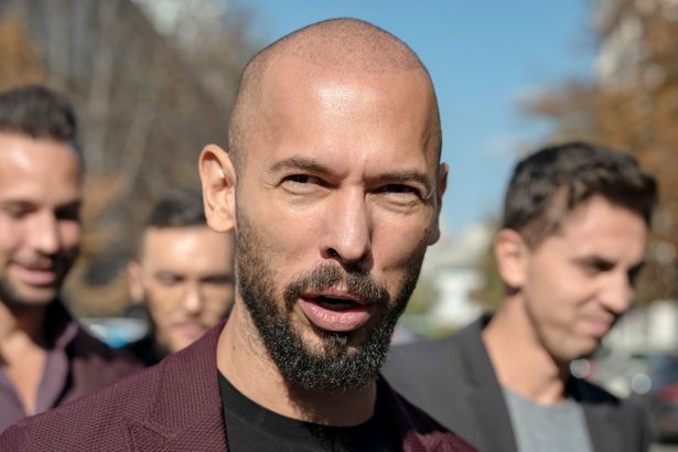 Andrew Tate talks to reporters outside the Court of Appeal on October 15, 2024 in Bucharest, Romania.