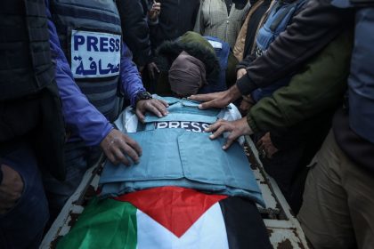 Mourners gather around the casket of Al Jazeera TV cameraman Ahmed El-Levh in Gaza on December 16.