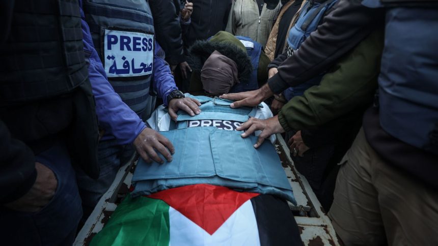 Mourners gather around the casket of Al Jazeera TV cameraman Ahmed El-Levh in Gaza on December 16.