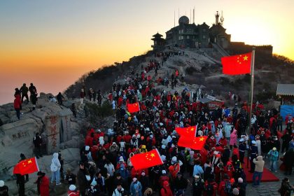 Climbers watch the sunrise on New Year's Day on Mount Tai on January 1, 2025, in Taian, Shandong Province in eastern China.