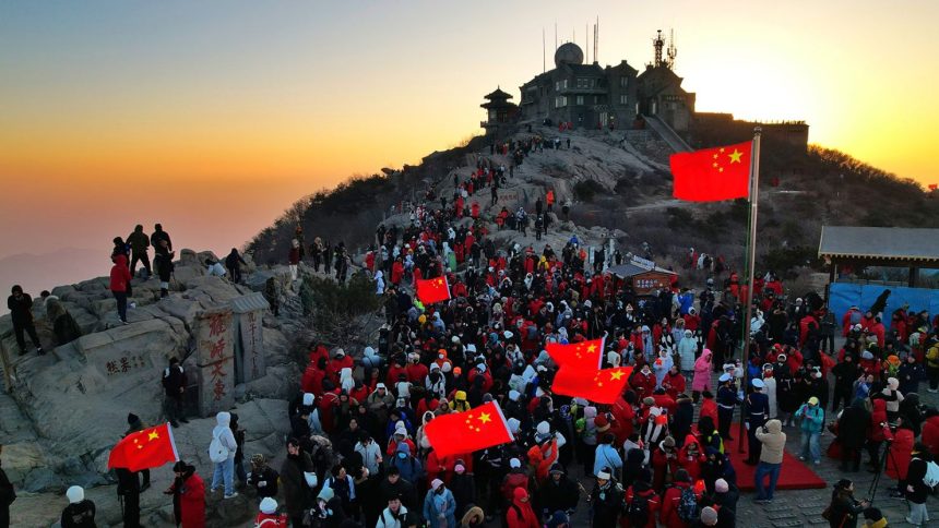 Climbers watch the sunrise on New Year's Day on Mount Tai on January 1, 2025, in Taian, Shandong Province in eastern China.