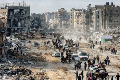 People walk past the rubble of collapsed buildings along Saftawi street in Jabalia in the northern Gaza Strip on January 20.