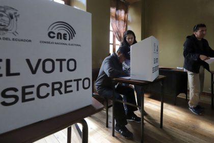 People vote at a polling station during the presidential election in Quito on February 9, 2025.