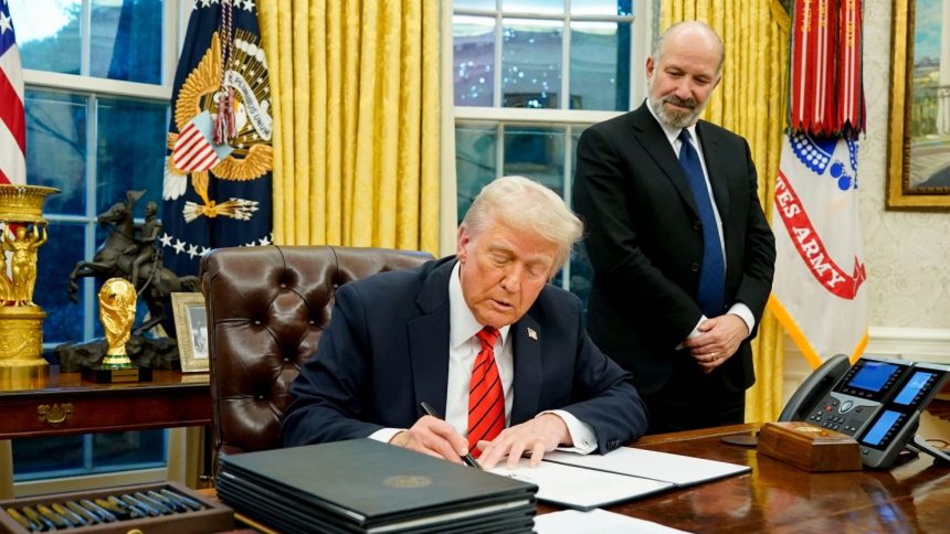 President Donald Trump signs executive actions in the Oval Office on Feb. 10, 2025.