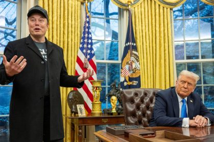 Elon Musk speaks about his federal cost-cutting efforts as US President Donald Trump looks on in the Oval Office of the White House on February 11.