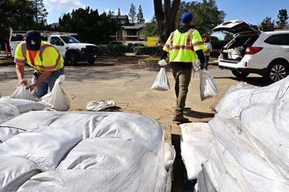 Pasadena residents load sandbags into their cars to prepare for the torrential rain in the forecast, which could trigger dangerous mudslides.