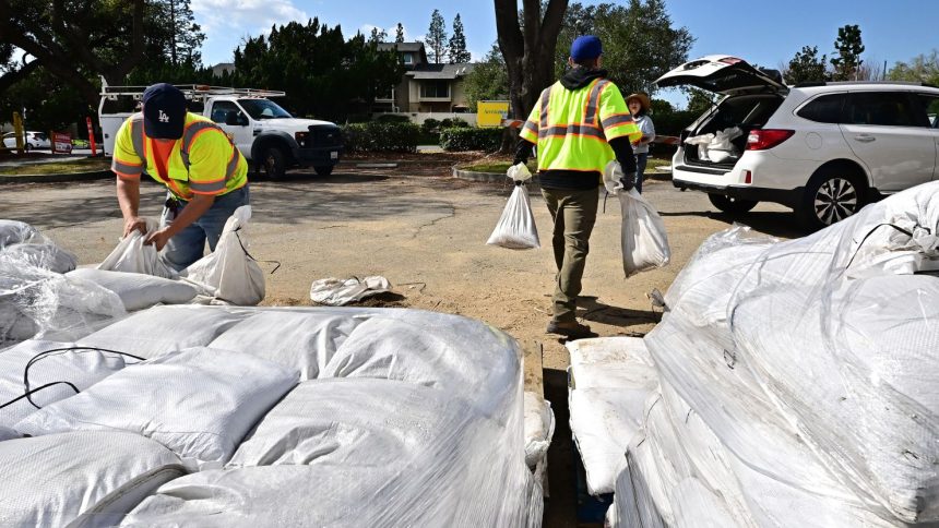 Pasadena residents load sandbags into their cars to prepare for the torrential rain in the forecast, which could trigger dangerous mudslides.