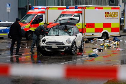 Members of the emergency services attend the scene of the incident where a car drove into a crowd in Munich, Germany, on Thursday.