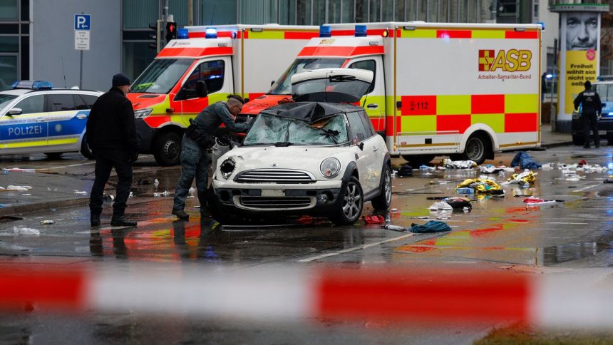 Members of the emergency services attend the scene of the incident where a car drove into a crowd in Munich, Germany, on Thursday.