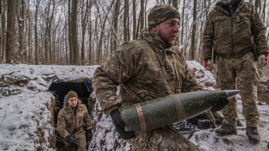 Ukrainian military carry ammunition in a forest in Kharkiv Oblast, Ukraine, on February 8.