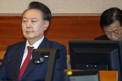 South Korea's impeached President Yoon Suk Yeol, left, attends his impeachment trial in Seoul on February 20, 2025.