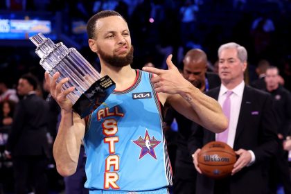 Golden State Warriors guard Stephen Curry poses with the 2025 KIA Kobe Bryant MVP trophy after leading Shaq's OGs to a win during the 74th NBA All-Star Game.