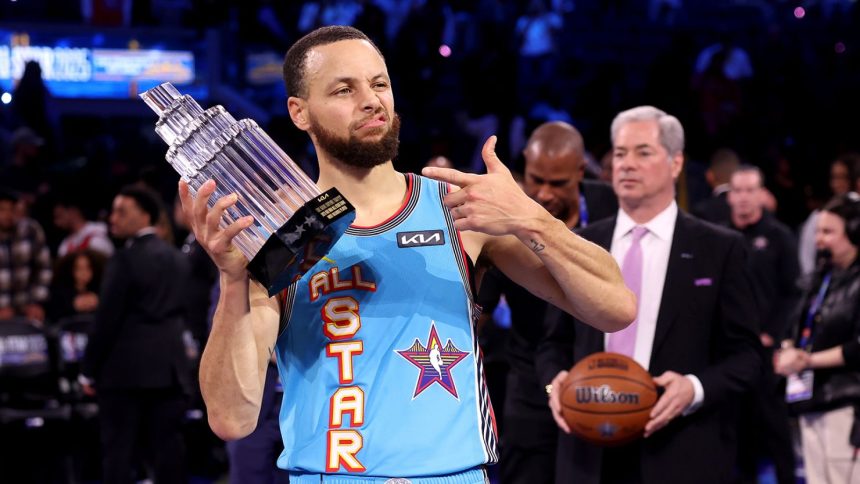 Golden State Warriors guard Stephen Curry poses with the 2025 KIA Kobe Bryant MVP trophy after leading Shaq's OGs to a win during the 74th NBA All-Star Game.