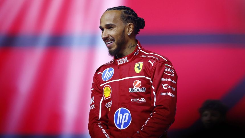 Lewis Hamilton smiles during a launch event at the O2 Arena in London, England.