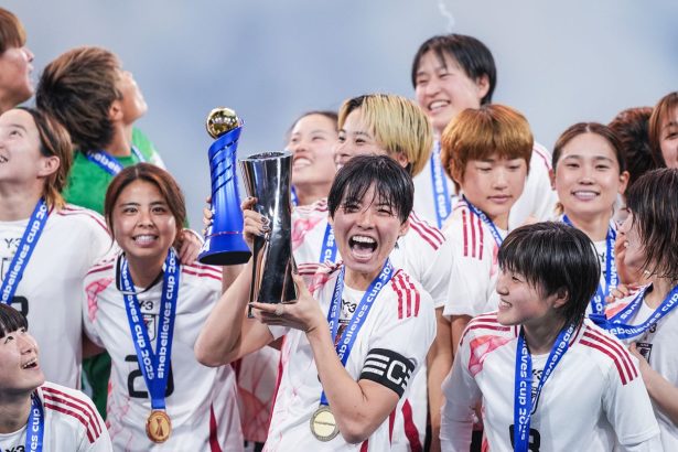 Japan's Saki Kumagai holds the SheBelieves Cup trophy after victory against the US.