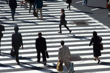 People hurry across the zebra crossing at the busy Shibuya intersection in Tokyo, Japan on August 4, 2013.