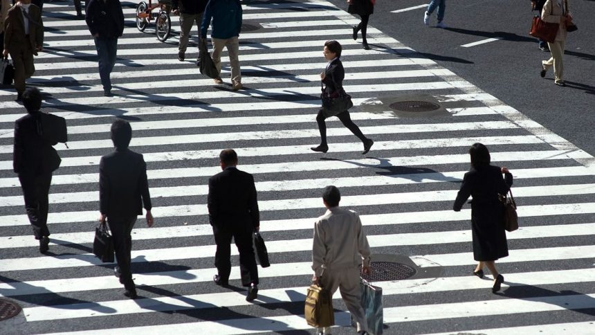 People hurry across the zebra crossing at the busy Shibuya intersection in Tokyo, Japan on August 4, 2013.