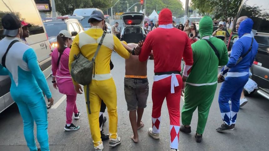 Police in Power Ranger costumes arrest a suspect during Carnival in São Paulo