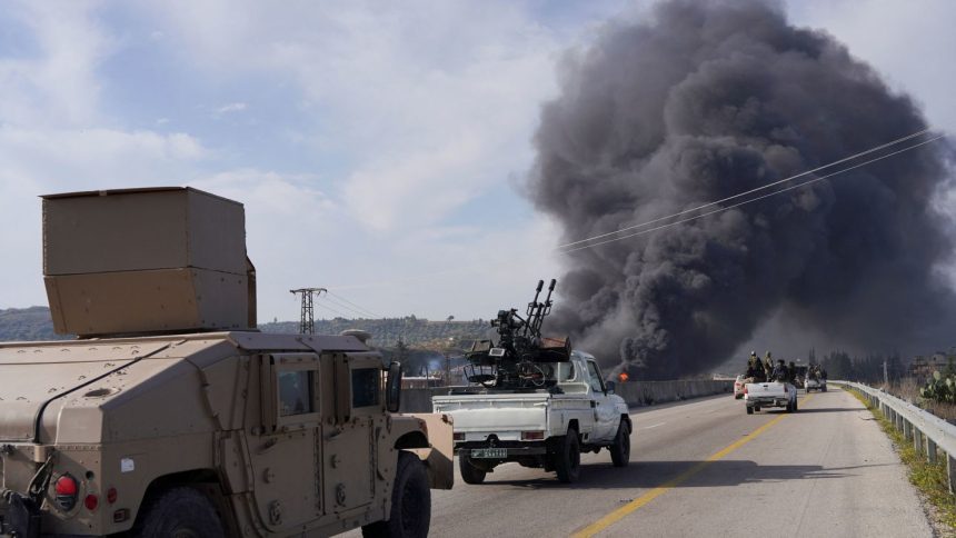 Syrian armed forces drive toward rising smoke as they battle pro-Bashar al-Assad fighters in Latakia, Syria, on Friday.