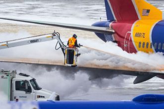 Crews deice a Southwest Airlines plane before takeoff in Omaha, Nebraska, in December 2022.