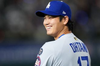 Ohtani smiles before the Dodgers' game against the Cubs in Tokyo.Masterpress/Getty Images