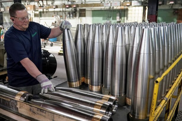 A worker handles metal projectiles at the Scranton Army Ammunition Plant in Pennsylvania in April 2024.