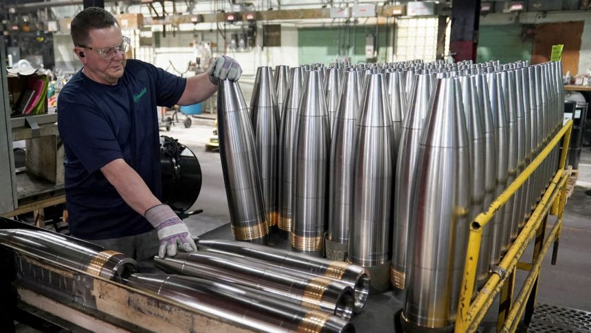 A worker handles metal projectiles at the Scranton Army Ammunition Plant in Pennsylvania in April 2024.