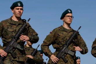 Volunteers practice drills during a military training project 'Holidays with the Army' aimed at promoting recruitment for the Polish army, in Kazun Nowy, Poland, July 26, 2024. REUTERS/Kuba Stezycki