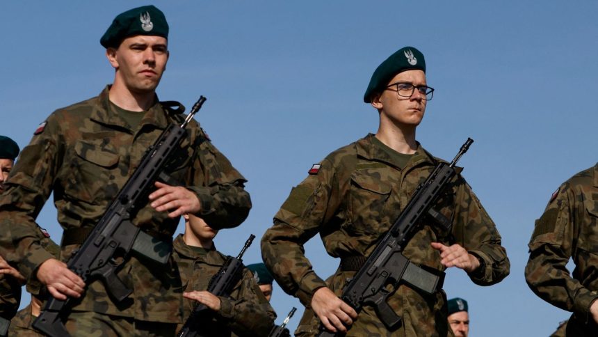 Volunteers practice drills during a military training project 'Holidays with the Army' aimed at promoting recruitment for the Polish army, in Kazun Nowy, Poland, July 26, 2024. REUTERS/Kuba Stezycki