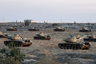 Egyptian military vehicles hold a position near the Rafah border crossing between Egypt and the Gaza Strip, amid a ceasefire between Israel and Hamas, in Rafah, Egypt on January 19.