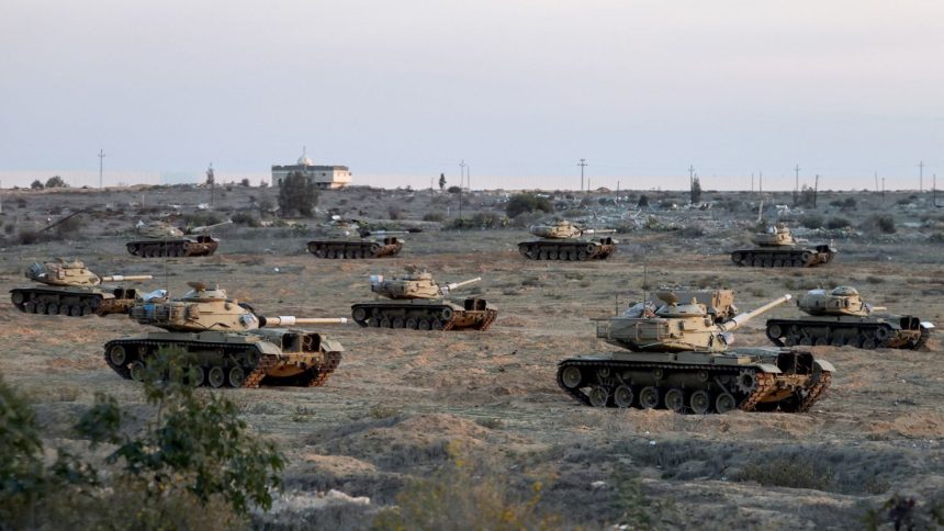 Egyptian military vehicles hold a position near the Rafah border crossing between Egypt and the Gaza Strip, amid a ceasefire between Israel and Hamas, in Rafah, Egypt on January 19.