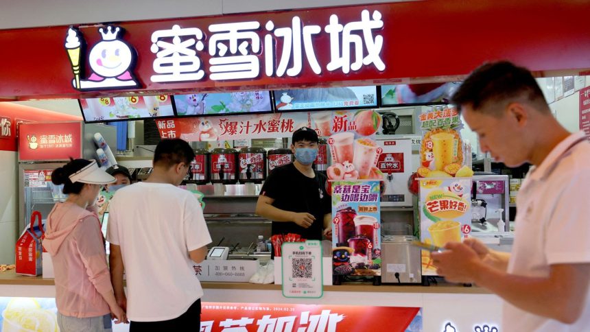 Customers wait at a Mixue Bingcheng bubble tea store at a shopping mall in Beijing, China last year.