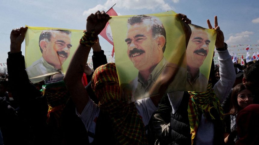 Supporters of pro-Kurdish Peoples' Equality and Democracy Party display flags with a portrait of jailed Kurdistan Workers Party leader Abdullah Ocalan during a rally in Istanbul in March 2024.