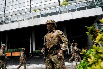 Police stand outside a hotel where migrants mainly from Asia and the Middle East were housed after being deported to Panama by the United States, in Panama City on February 18, 2025.