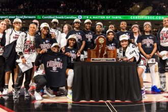 South Carolina Gamecocks players pose with the 2024-25 SEC Regular Season Championship Trophy after defeating the Kentucky Wildcats on Sunday.