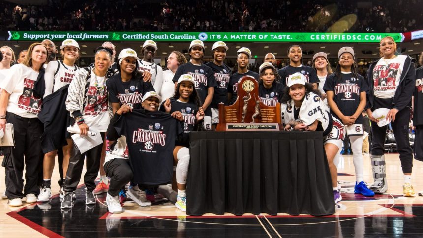 South Carolina Gamecocks players pose with the 2024-25 SEC Regular Season Championship Trophy after defeating the Kentucky Wildcats on Sunday.