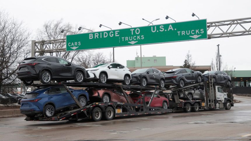 A car hauler drives towards the Ambassador Bridge to Detroit, Michigan from Windsor, Ontario, Canada, March 4, 2025.