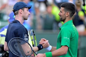 Novak Djokovic shakes hand with Botic van de Zandschulp after their match.