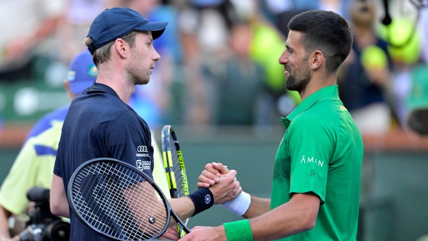 Novak Djokovic shakes hand with Botic van de Zandschulp after their match.