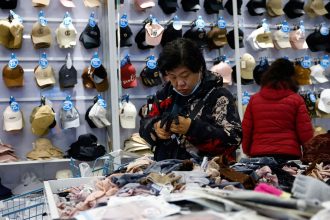 Customers shop for gloves at the Wankelai store in Beijing in February 2025.