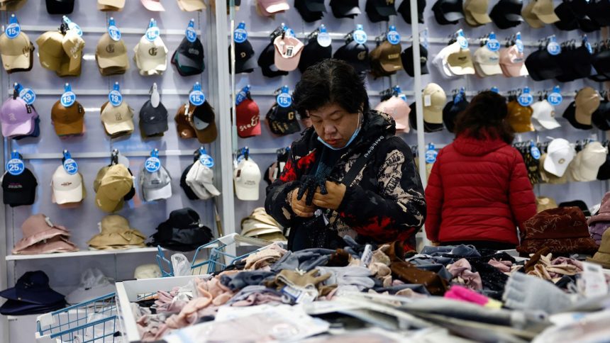 Customers shop for gloves at the Wankelai store in Beijing in February 2025.