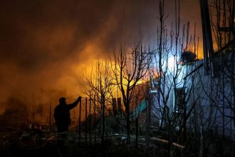 Rescuers respond to a Russian air strike in Ukraine's Kherson region on Friday.