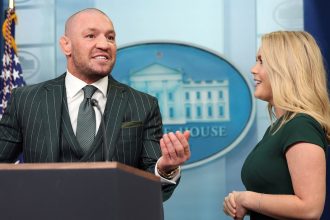 Irish MMA fighter Conor McGregor speaks at the briefing room lectern, with White House press secretary Karoline Leavitt at his side, during a visit to the White House on March 17, 2025.