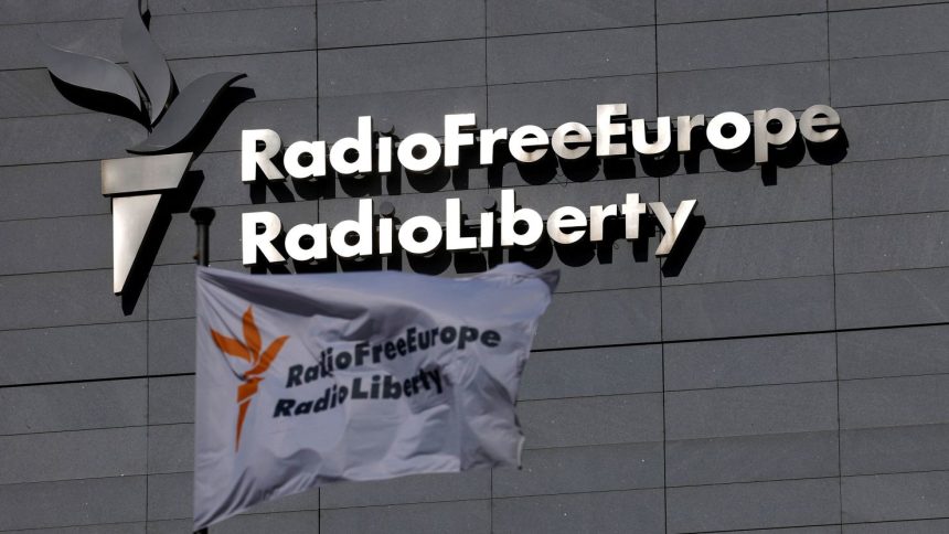 A flag and a sign of Radio Free Europe/Radio Liberty.