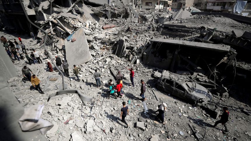 Palestinians inspect the site of an Israeli strike on a residential building in Jabalia in the northern Gaza Strip on Tuesday.