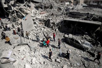 Palestinians inspect the site of an Israeli strike on a residential building in Jabalia in the northern Gaza Strip on March 18, 2025.