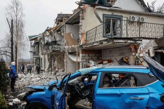 Damaged homes and a car at a site of a Russian drone strike in the Ukrainian town of Hostomel in Kyiv Oblast on March 19, 2025.