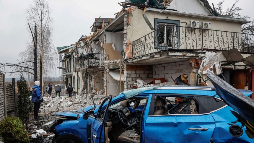 Damaged homes and a car at a site of a Russian drone strike in the Ukrainian town of Hostomel in Kyiv Oblast on March 19, 2025.